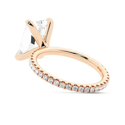 Rose gold 5ct radiant cut moissanite engagement ring tilted side profile view showing prong setting