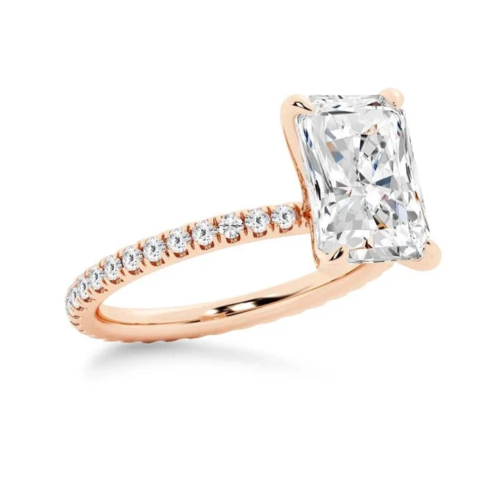 Rose gold 5ct radiant cut moissanite engagement ring 3/4 side perspective view showing eternity pave band