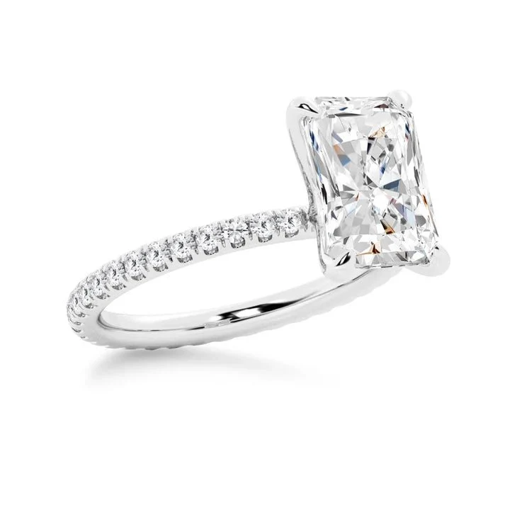 White gold 5ct radiant cut moissanite engagement ring 3/4 side perspective view showing eternity pave band