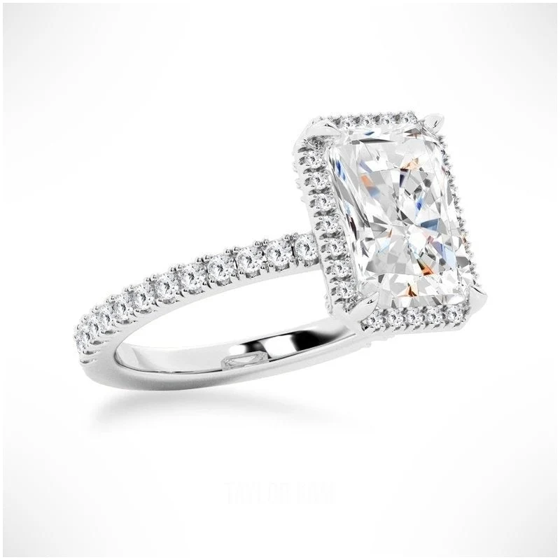 White gold radiant cut moissanite halo engagement ring 3/4 side low angle view showing basket details