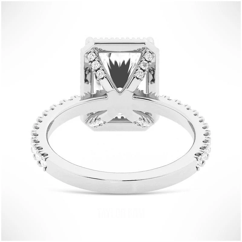 White gold radiant cut moissanite halo engagement ring side view showing pave studded basket prongs