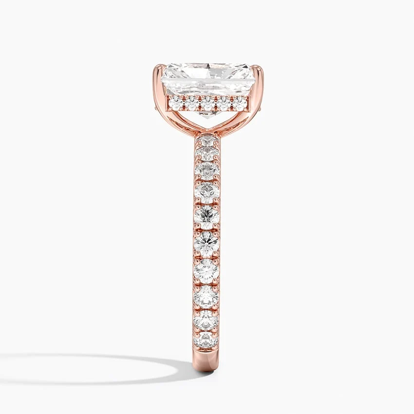 Rose gold radiant cut moissanite engagement ring direct side profile view showing hidden halo basket