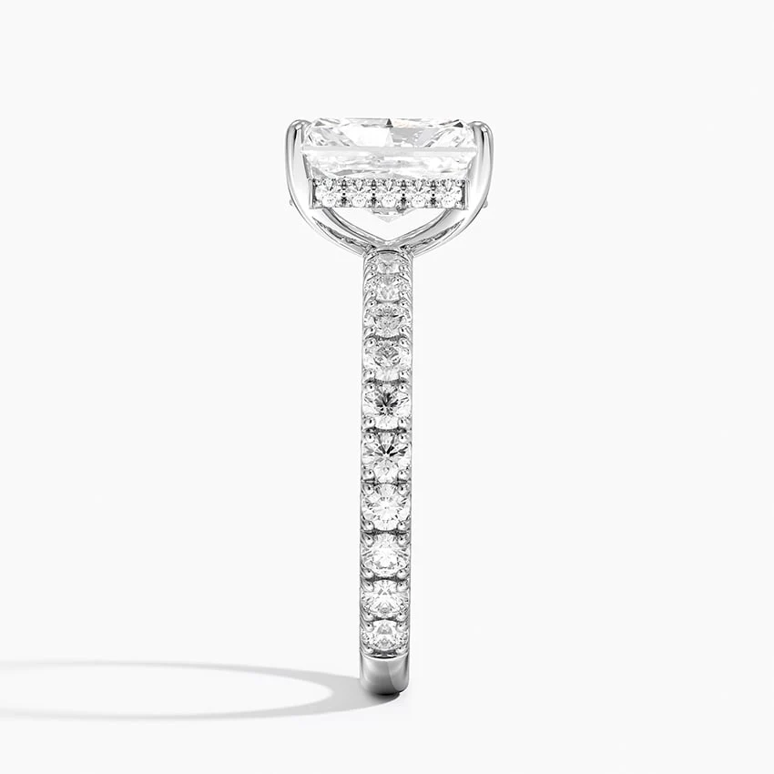 White gold radiant cut moissanite engagement ring direct side profile view showing hidden halo basket