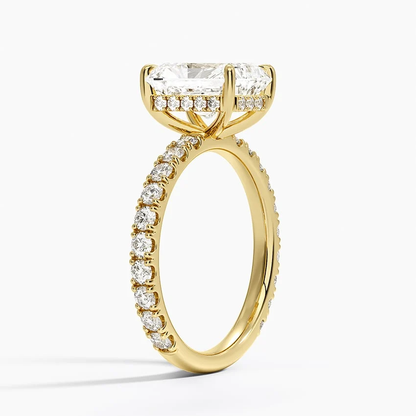 Yellow gold radiant cut moissanite engagement ring 3/4 side perspective view showing claw prongs and scalloped shank