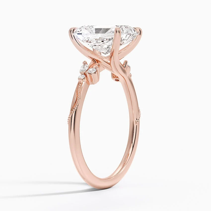 Rose gold radiant cut moissanite engagement ring top view with delicate nature inspired cluster accents