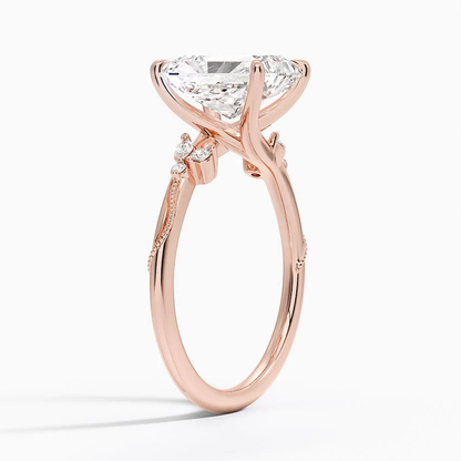 Rose gold radiant cut moissanite engagement ring top view with delicate nature inspired cluster accents