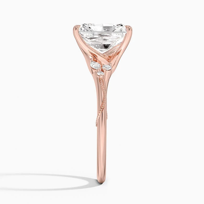 Rose gold radiant cut moissanite engagement ring direct side profile view showing milgrain vine band and cluster side accents