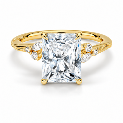 Yellow gold radiant cut moissanite engagement ring top view with delicate nature inspired cluster accents