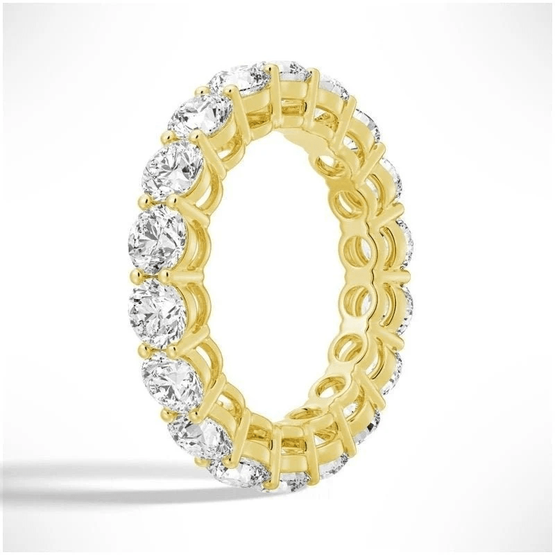 Angled profile view of Round Cut Moissanite Full Eternity Band with Shared Prong Setting in Yellow Gold - Novelle Vow