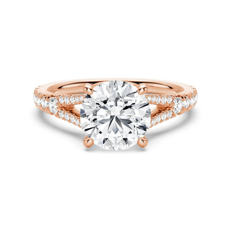Rose gold round brilliant cut moissanite engagement ring with split shank and pave accents