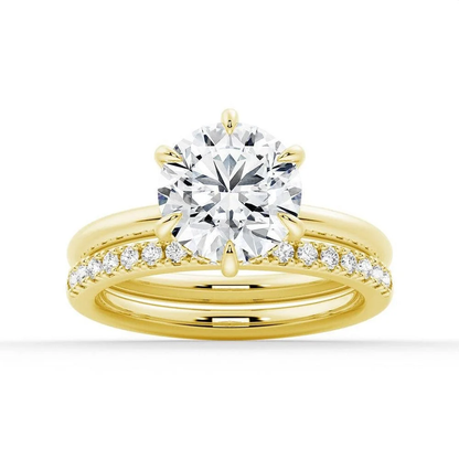 Yellow gold round moissanite bridal set with six-prong solitaire and pave wedding band