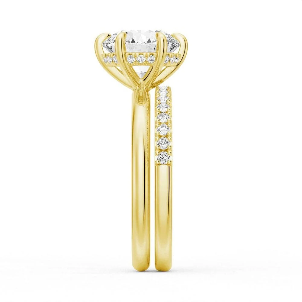 Yellow gold round moissanite bridal set direct side profile view showing six-prong basket and pave band