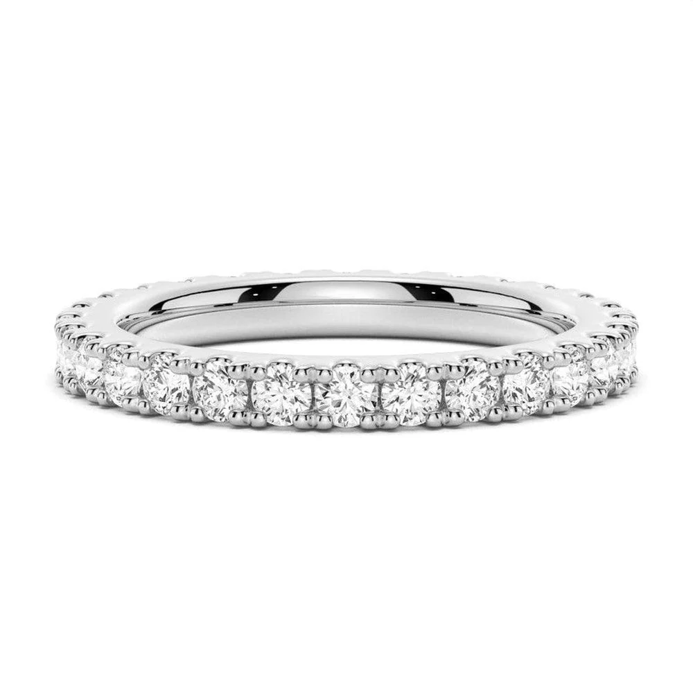 White gold round moissanite eternity wedding band top view with brilliant pave stones