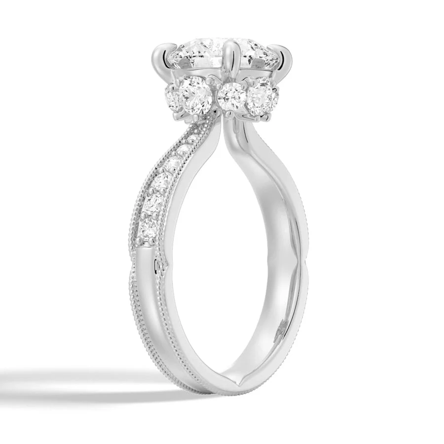 3/4 perspective side view of white gold round moissanite engagement ring with hidden halo accent stones