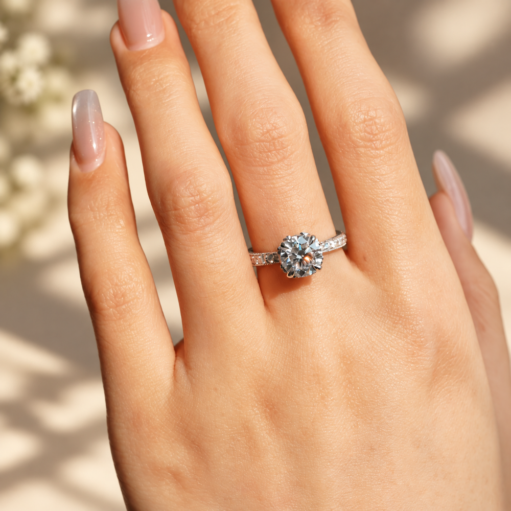 1.5ct round moissanite engagement ring on hand close up