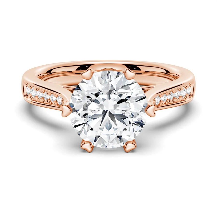 Rose gold round moissanite engagement ring top view showcasing round centerpiece and pave band