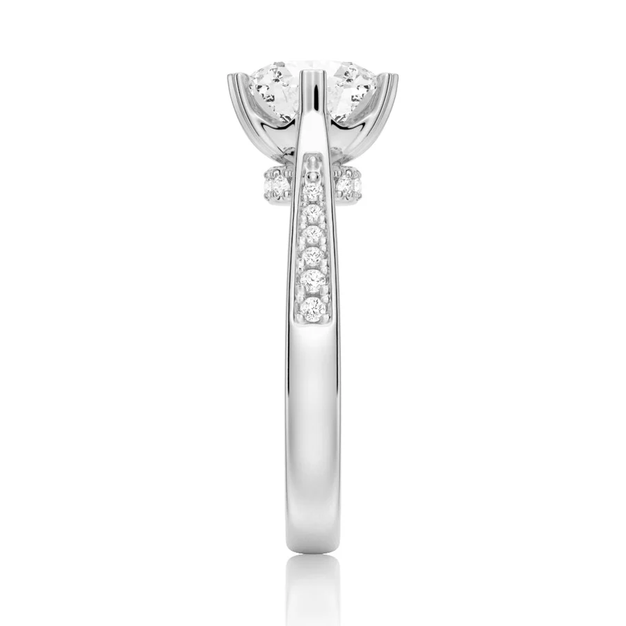 White gold round moissanite ring side profile view displaying pave shank