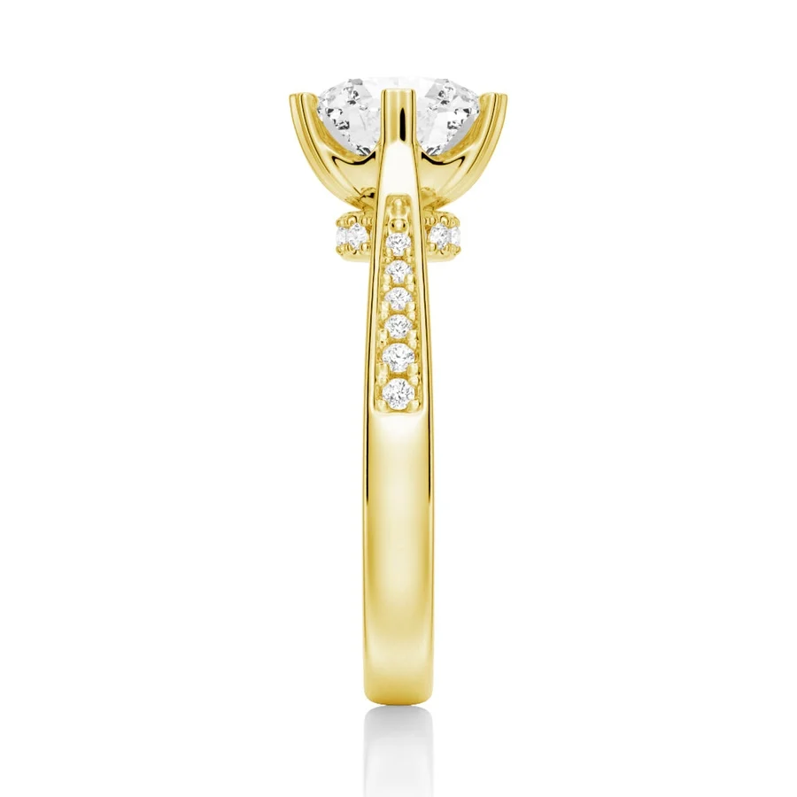 Yellow gold round moissanite ring side view displaying pave band and hidden accents