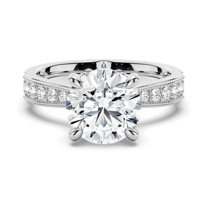 NOVELLE VOW white gold round moissanite engagement ring top view with 4 prongs and milgrain pave shank
