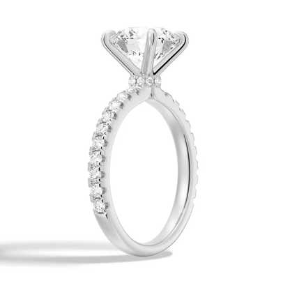 Perspective side angle of round moissanite engagement ring with hidden halo in white gold
