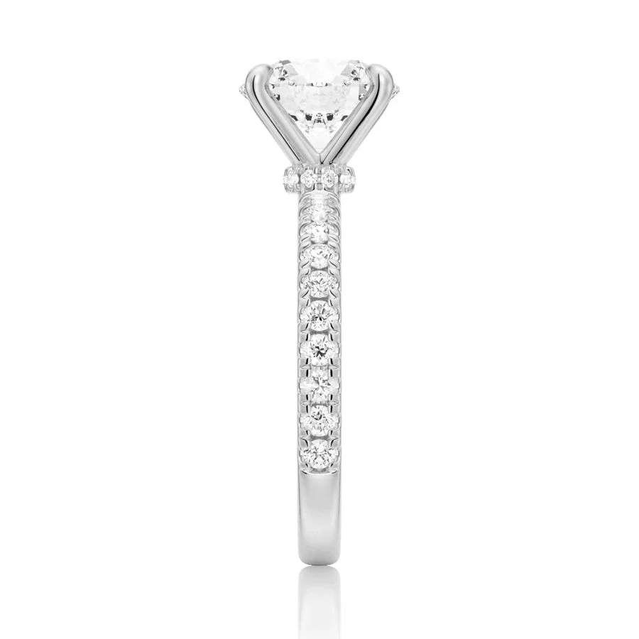 Side profile view showing hidden halo detail on round moissanite engagement ring in white gold