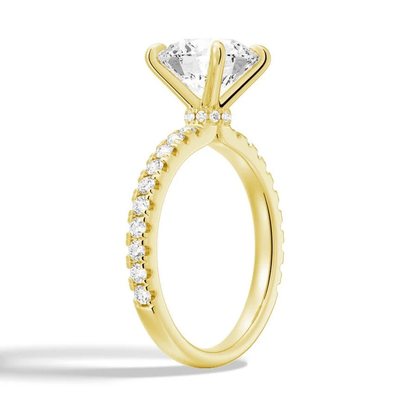 Perspective side angle of round moissanite engagement ring with hidden halo in yellow gold