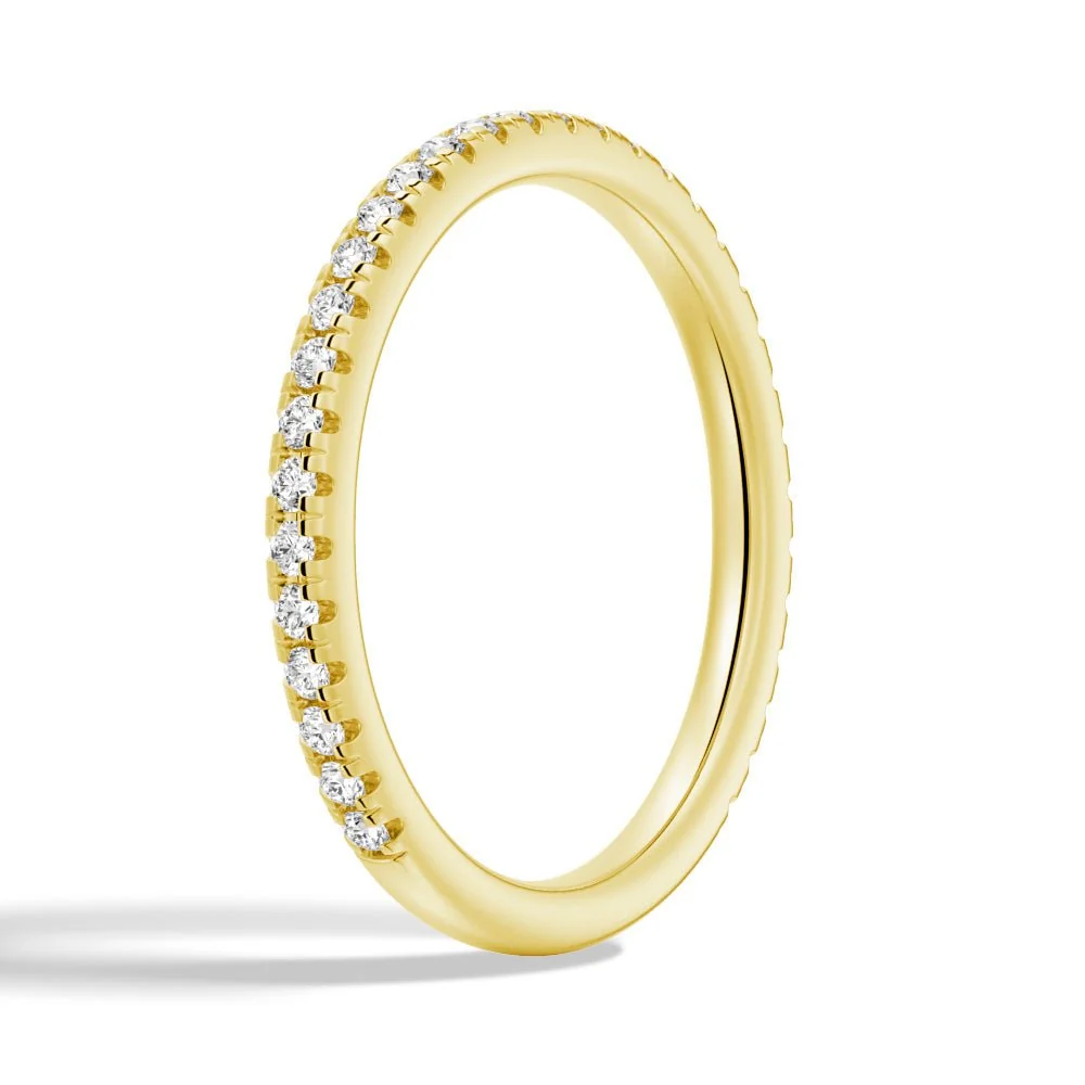 Three-quarter perspective view of 1.7mm round moissanite pave band in yellow gold