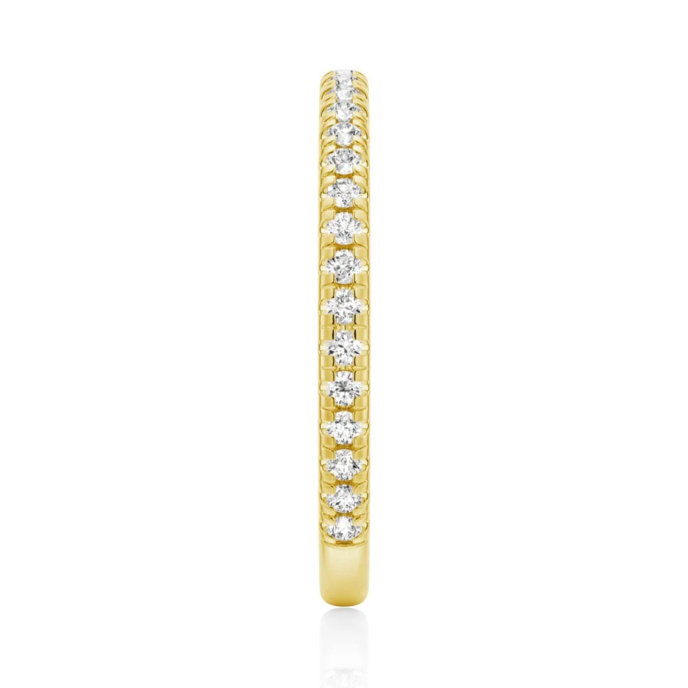 Top view showing 2mm pave set moissanite eternity band in yellow gold