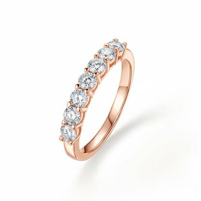 Angled profile view of 7 Stone Round Moissanite Wedding Band with Shared Prong Setting in Rose Gold
