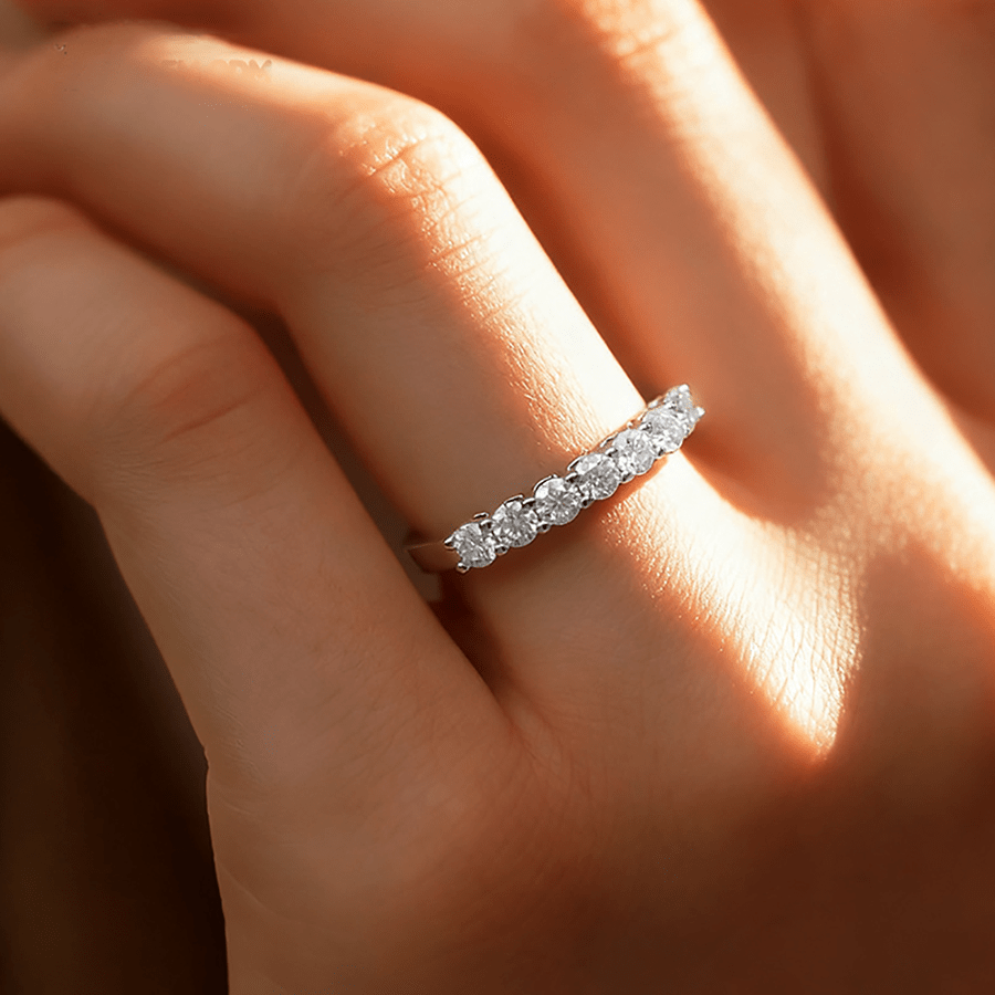 7 Stone Round Moissanite Wedding Band with Shared Prong Setting in White Gold on hand styling - Novelle Vow