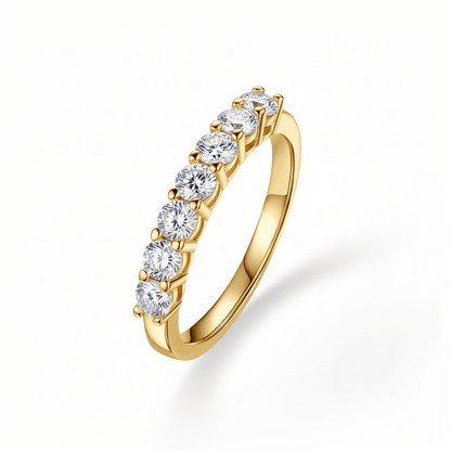 Angled profile view of 7 Stone Round Moissanite Wedding Band with Shared Prong Setting in Yellow Gold