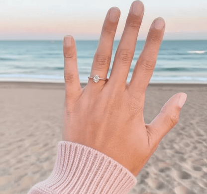 The Classic Oval Solitaire Moissanite Engagement Ring Timeless and Elegant style in White Gold on hand styling