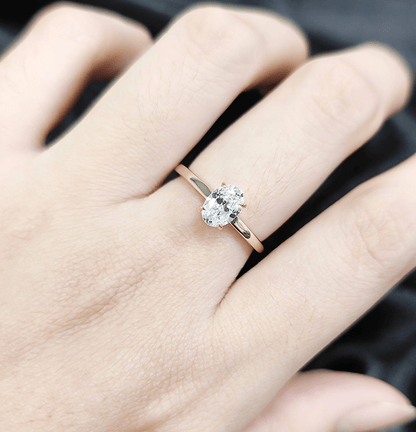 The Classic Oval Solitaire Moissanite Engagement Ring Timeless and Elegant style in Yellow Gold on hand styling - Novelle Vow