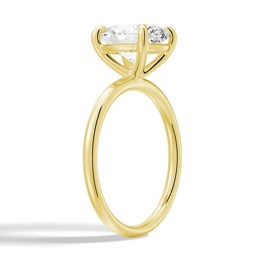 Angled profile view of The Classic Oval Solitaire Moissanite Engagement Ring Timeless and Elegant style in Yellow Gold 