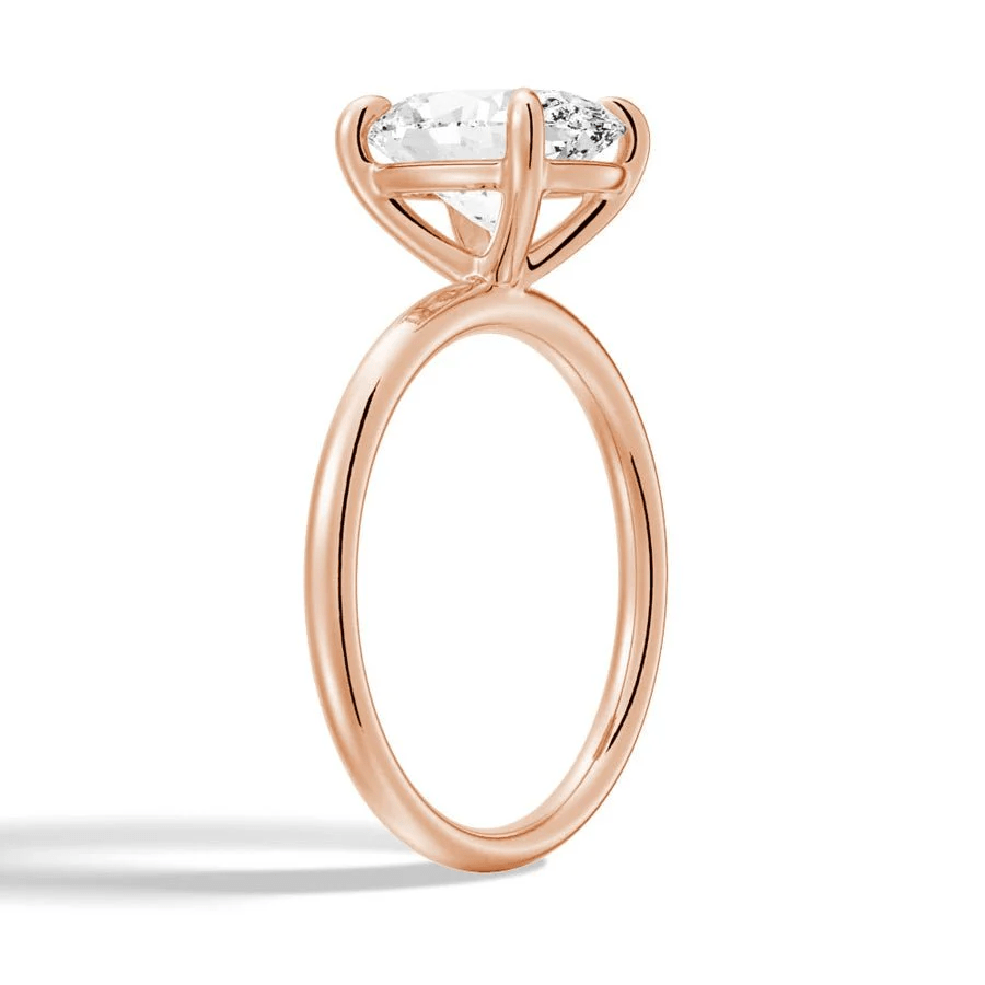 Angled profile view of The Classic Oval Solitaire Moissanite Engagement Ring Timeless and Elegant style in Rose Gold 