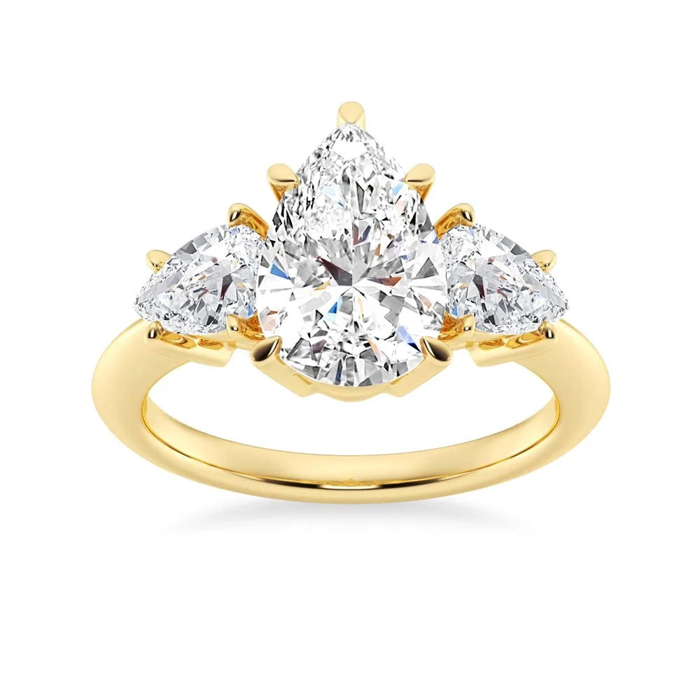 Yellow gold three stone pear moissanite engagement ring top view with plain band