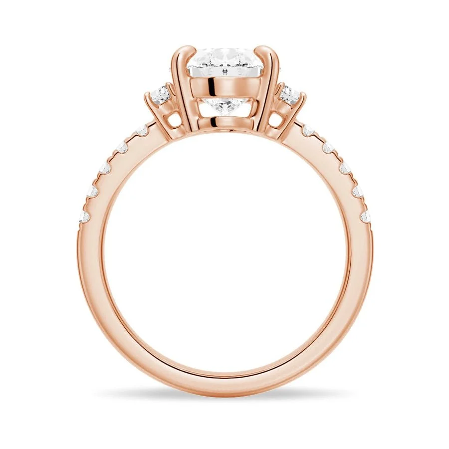 Rose gold three-stone oval moissanite engagement ring direct side profile view