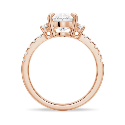 Rose gold three-stone oval moissanite engagement ring direct side profile view