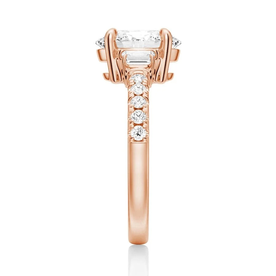 Rose gold three-stone oval moissanite ring side view displaying pave band details