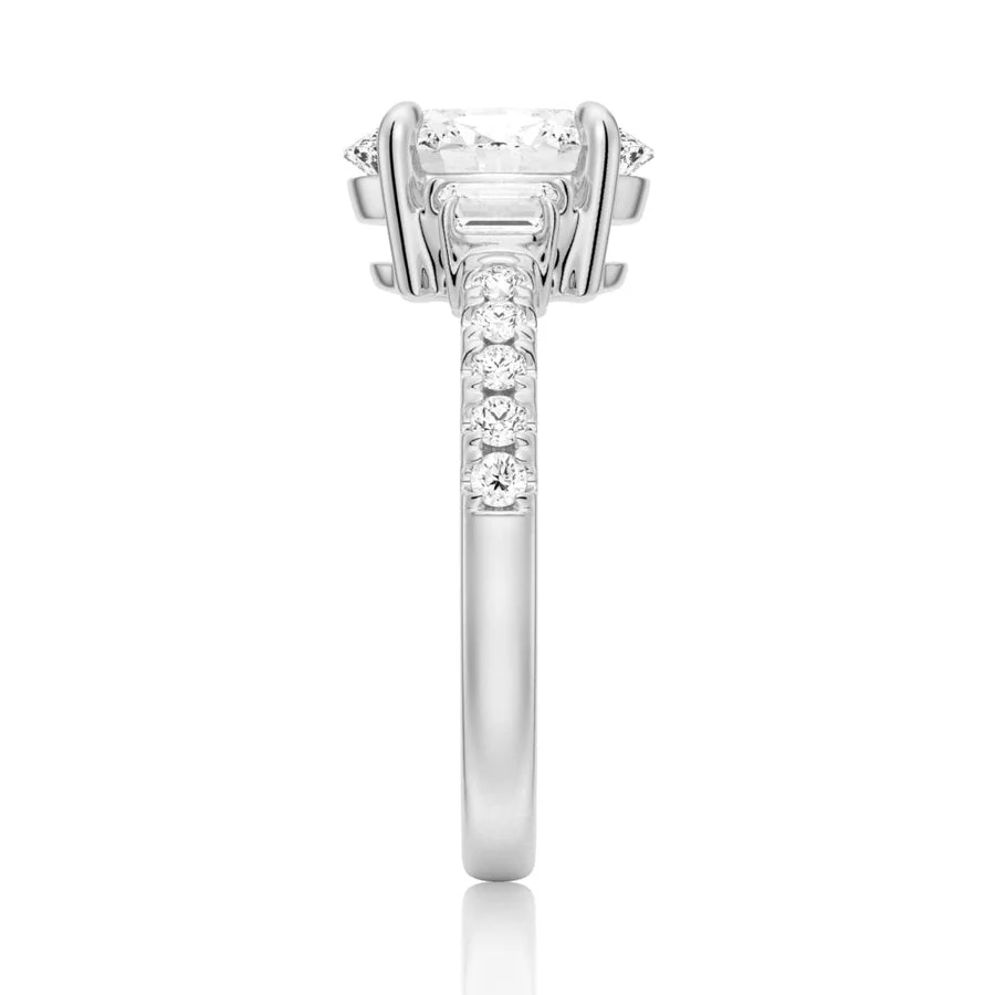 White gold three-stone oval moissanite ring side view displaying pave band details