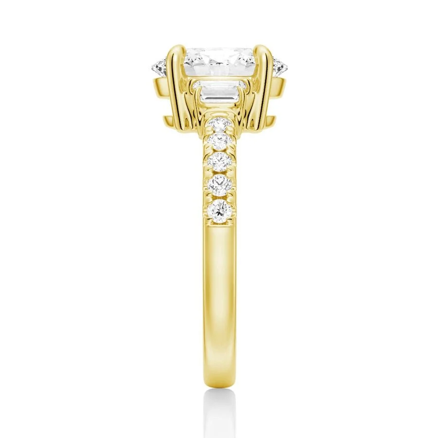 Yellow gold three-stone oval moissanite ring side view displaying pave band details