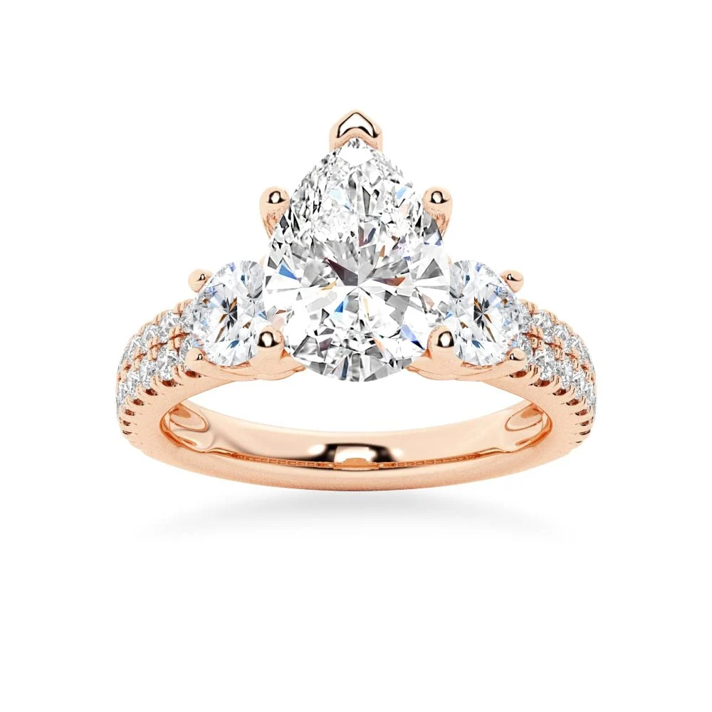 Rose gold three stone pear moissanite engagement ring top view with double row pave accent band