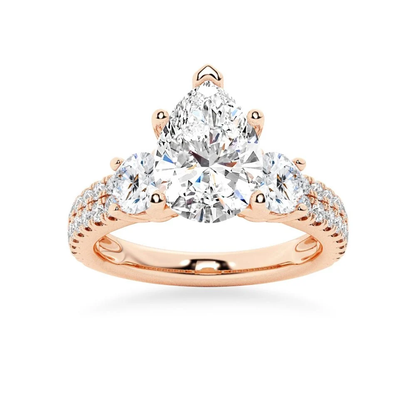 Rose gold three stone pear moissanite engagement ring top view with double row pave accent band