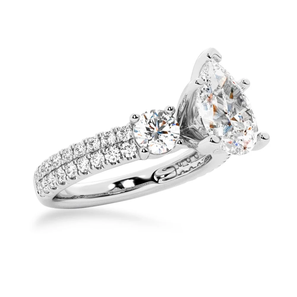 White gold three stone pear moissanite ring 3/4 perspective view showing double row pave setting
