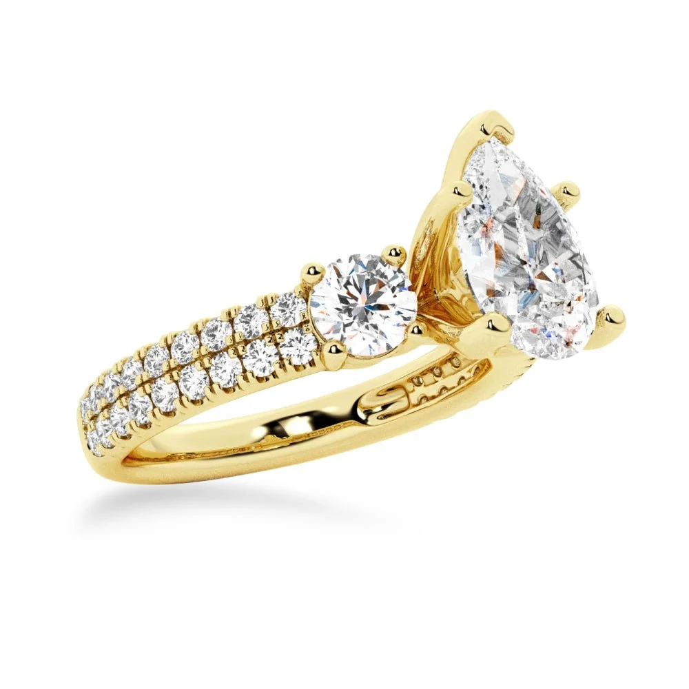 Yellow gold three stone pear moissanite engagement ring 3/4 perspective view showcasing double row pave setting