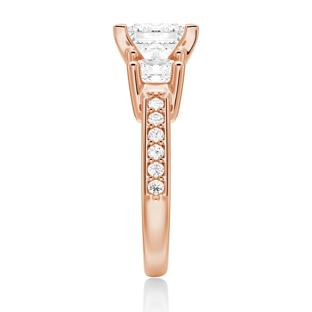 Rose gold three-stone princess-cut moissanite ring side view displaying pave band details