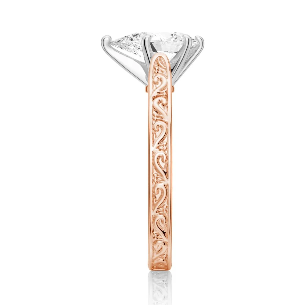 Rose gold vintage pear-cut moissanite engagement ring profile view displaying basket prongs
