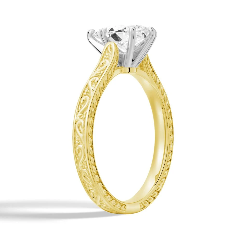 Yellow gold vintage pear-cut moissanite engagement ring 3/4 angle view with milgrain engraved band