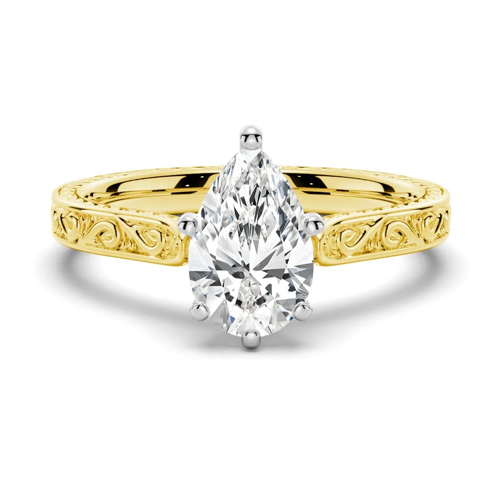 Yellow gold vintage pear-cut moissanite engagement ring top view with antique scrollwork